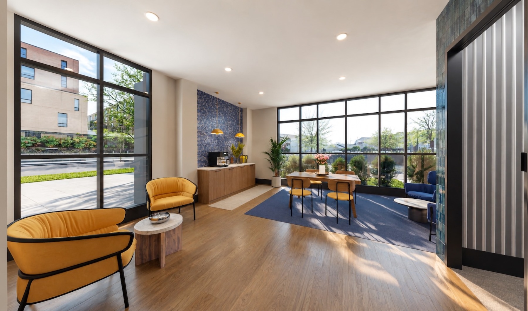 a lounge with seating and large windows