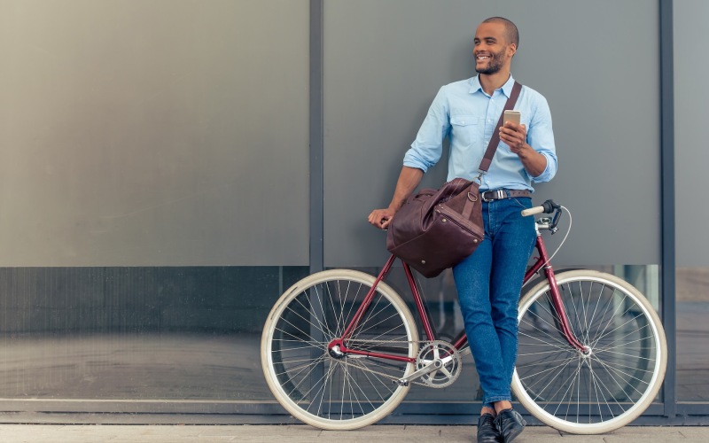 a person standing front of a bicycle
