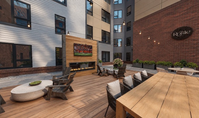 patio with seating tables fireplace and tv